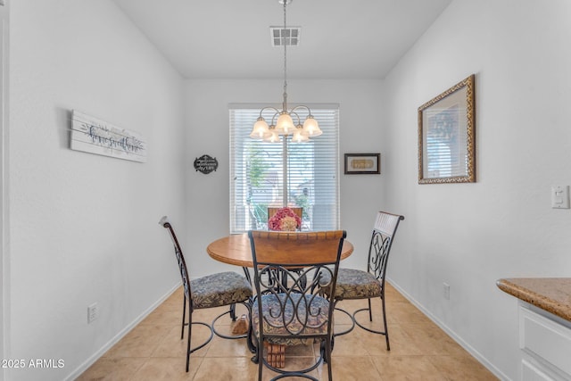 dining area with light tile patterned floors and an inviting chandelier