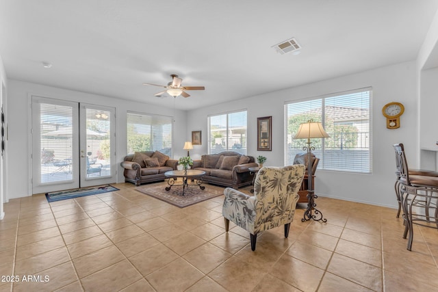 living room featuring ceiling fan and light tile patterned floors