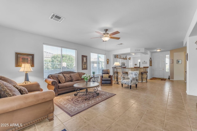 living room with light tile patterned floors and ceiling fan