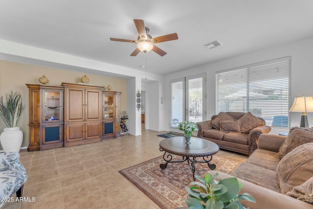 living room with light tile patterned floors and ceiling fan