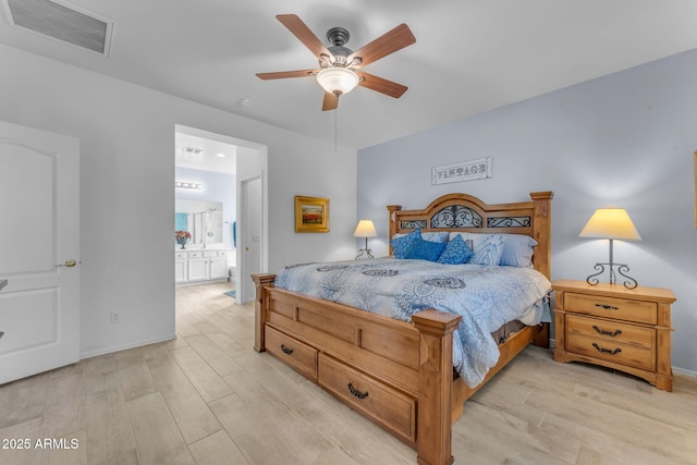 bedroom with ensuite bathroom, ceiling fan, and light hardwood / wood-style floors