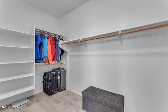 walk in closet featuring light hardwood / wood-style flooring