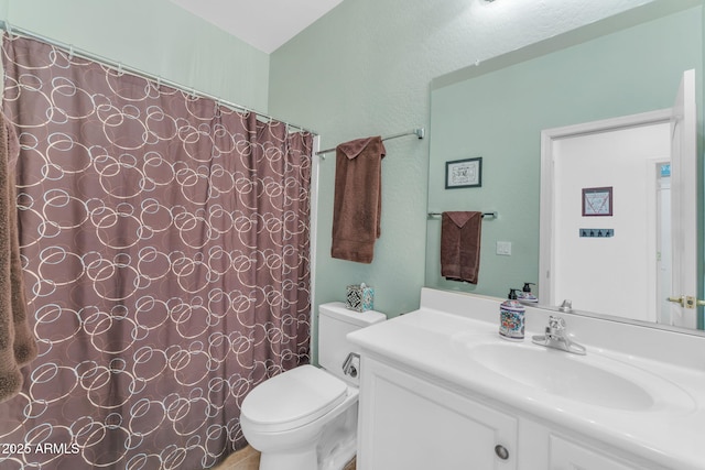 bathroom with vanity, a shower with shower curtain, and toilet