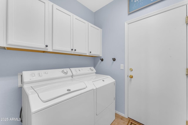 laundry room featuring cabinets and washing machine and clothes dryer