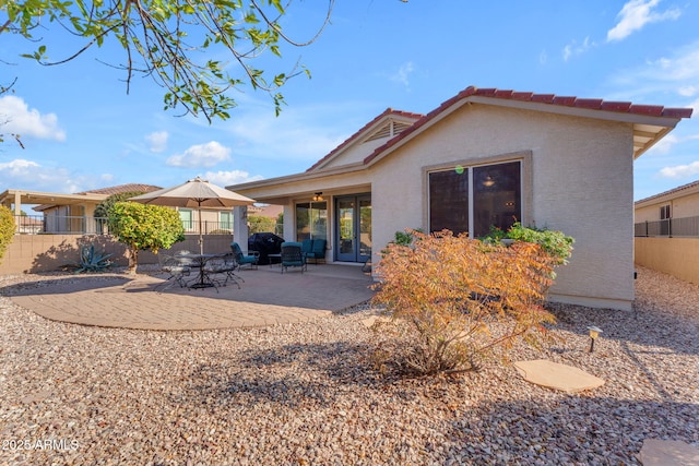 back of property with a patio