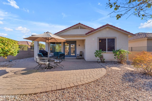 rear view of house with french doors and a patio