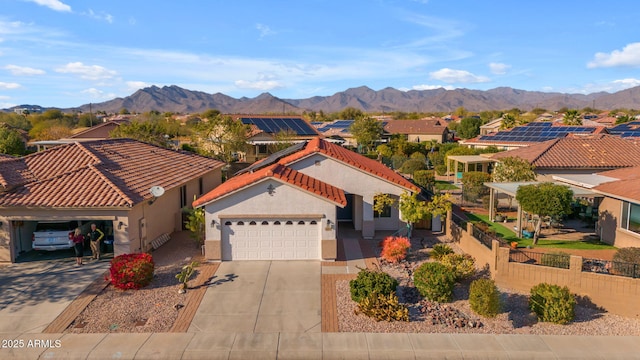 view of front facade featuring a garage and a mountain view