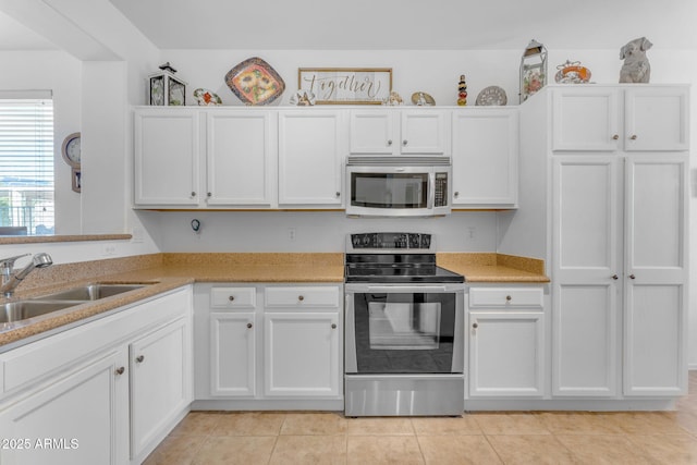 kitchen featuring white cabinetry, appliances with stainless steel finishes, and sink