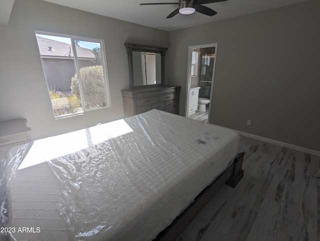 bedroom featuring ensuite bath and ceiling fan