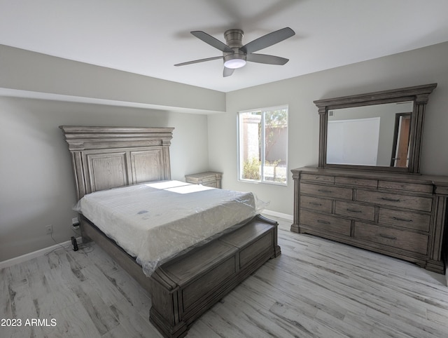 bedroom with ceiling fan and light hardwood / wood-style flooring