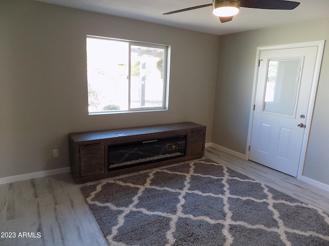 living area with plenty of natural light, light hardwood / wood-style floors, and ceiling fan