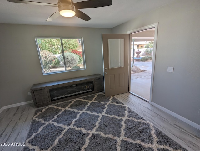 spare room featuring light hardwood / wood-style flooring and ceiling fan