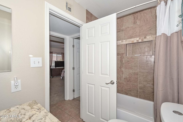 bathroom with tile patterned floors, toilet, visible vents, and shower / tub combo with curtain