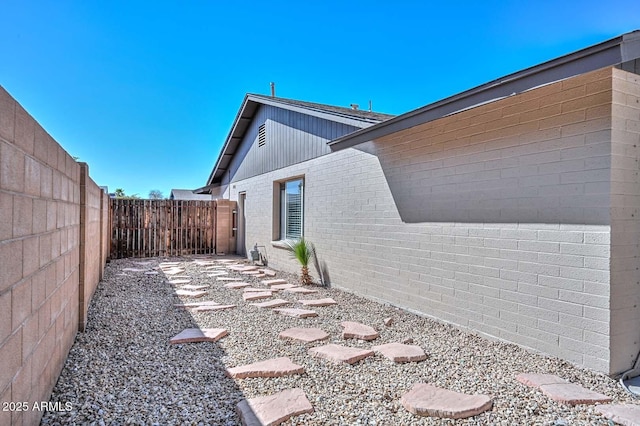 view of side of home featuring a fenced backyard