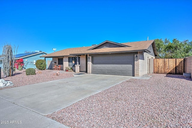 ranch-style house featuring fence, concrete driveway, a shingled roof, a garage, and brick siding