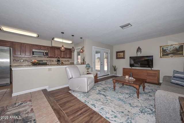 living room with a textured ceiling and wood finished floors