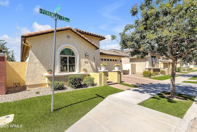 3634 E Perkinsville St, Gilbert, AZ 85295 - mediterranean / spanish-style home featuring stucco siding, a garage, a tile roof, a front lawn, and driveway