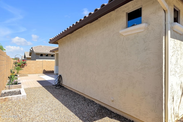 3634 E Perkinsville St, Gilbert, AZ 85295 - view of home's exterior featuring a fenced backyard, a patio area, stucco siding, and a tile roof
