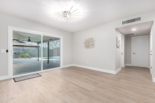 spare room featuring ceiling fan and light wood-type flooring