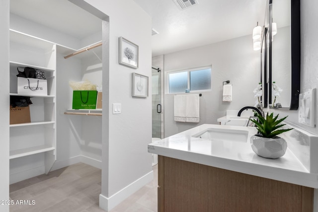 bathroom with vanity, an enclosed shower, and wood-type flooring