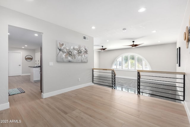 unfurnished room featuring ceiling fan and light hardwood / wood-style floors