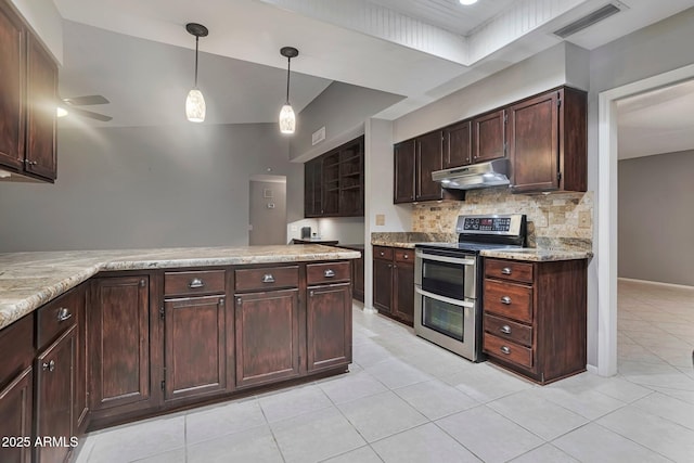 kitchen featuring visible vents, under cabinet range hood, decorative light fixtures, range with two ovens, and decorative backsplash