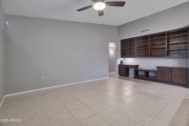 unfurnished living room featuring visible vents, baseboards, ceiling fan, light tile patterned floors, and built in study area