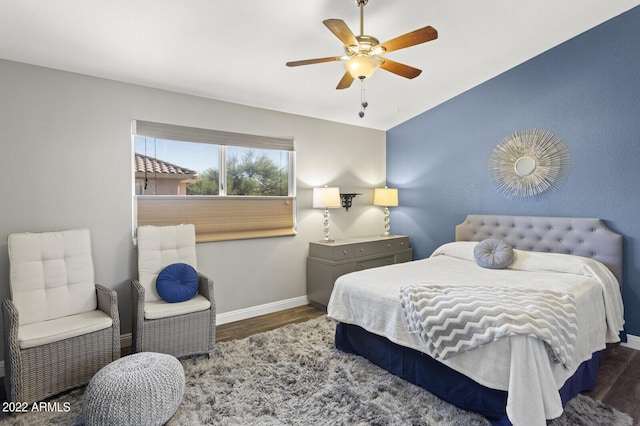 bedroom featuring dark hardwood / wood-style floors and ceiling fan