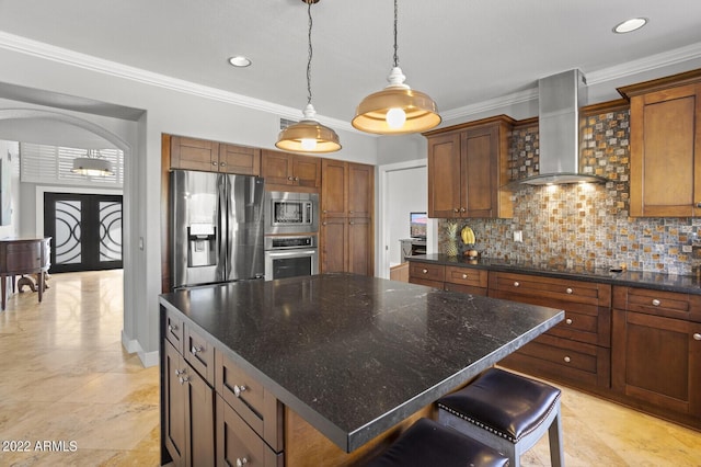 kitchen featuring french doors, a kitchen island, stainless steel appliances, decorative backsplash, and wall chimney range hood