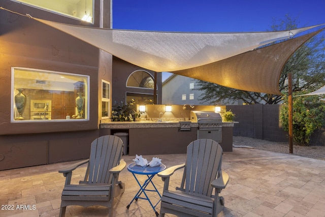 view of patio featuring grilling area, exterior kitchen, and sink