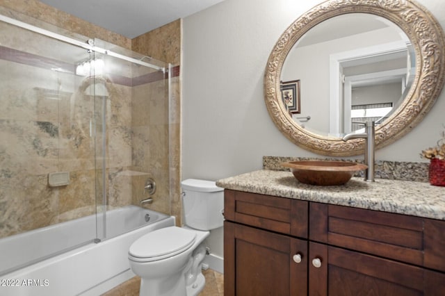 full bathroom with enclosed tub / shower combo, vanity, and toilet