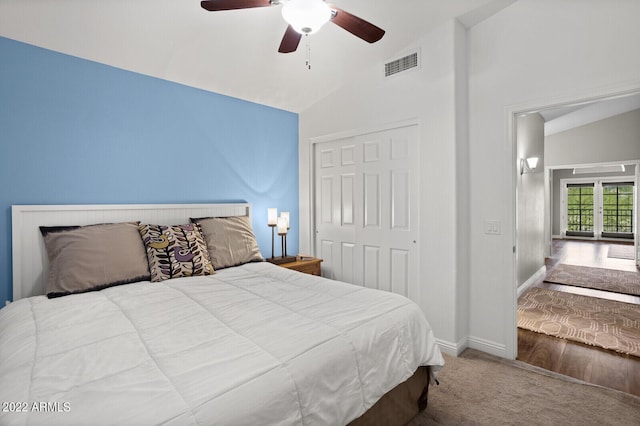 carpeted bedroom featuring vaulted ceiling, ceiling fan, and a closet