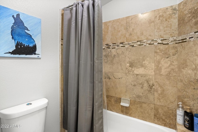 bathroom with toilet and shower / bath combo with shower curtain