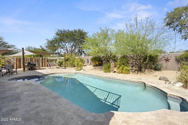 view of pool with an in ground hot tub and a patio