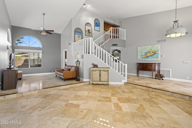 entrance foyer featuring a high ceiling and ceiling fan