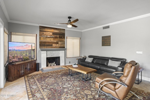 living room with crown molding, a large fireplace, and ceiling fan