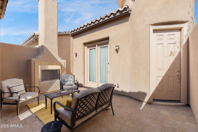 view of patio featuring exterior fireplace