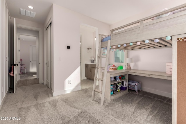 bedroom with light colored carpet and a closet