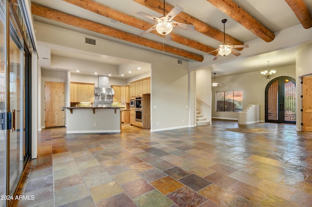 35824 N Tom Darlington Dr, Carefree, AZ 85377 - unfurnished living room with ceiling fan, stone tile floors, baseboards, stairs, and beamed ceiling