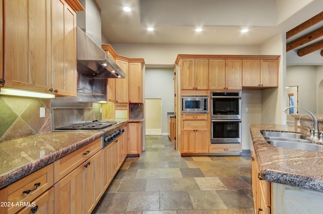 35824 N Tom Darlington Dr, Carefree, AZ 85377 - kitchen with stainless steel appliances, a sink, backsplash, wall chimney exhaust hood, and recessed lighting