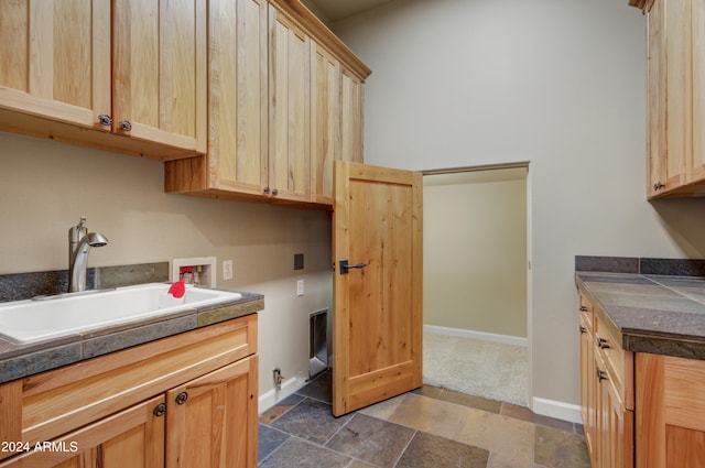 35824 N Tom Darlington Dr, Carefree, AZ 85377 - laundry area with hookup for a washing machine, hookup for a gas dryer, baseboards, dark stone finish floors, and cabinet space