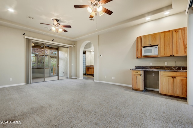 35824 N Tom Darlington Dr, Carefree, AZ 85377 - kitchen with white microwave, ceiling fan, arched walkways, recessed lighting, and light carpet