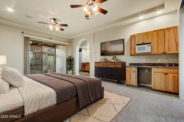 35824 N Tom Darlington Dr, Carefree, AZ 85377 - bedroom with recessed lighting, arched walkways, light colored carpet, a sink, and access to outside