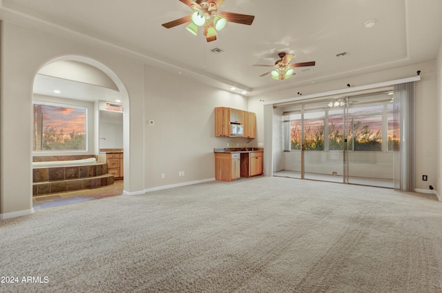 35824 N Tom Darlington Dr, Carefree, AZ 85377 - unfurnished living room with ceiling fan, light colored carpet, plenty of natural light, and arched walkways