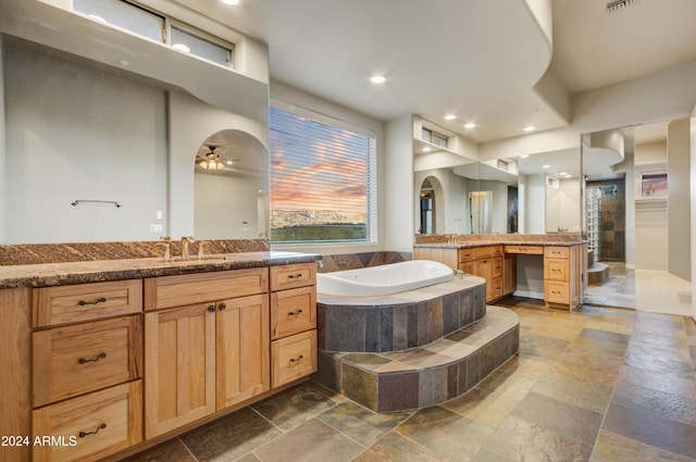 35824 N Tom Darlington Dr, Carefree, AZ 85377 - full bathroom featuring stone tile floors, a bath, a stall shower, two vanities, and recessed lighting