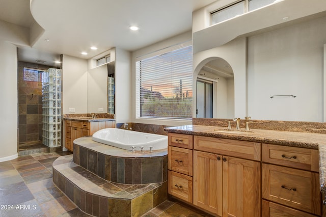 35824 N Tom Darlington Dr, Carefree, AZ 85377 - bathroom featuring stone tile flooring, a garden tub, a tile shower, plenty of natural light, and recessed lighting