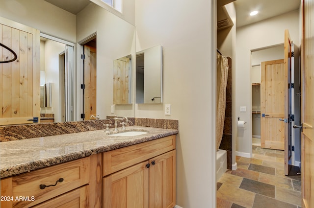 35824 N Tom Darlington Dr, Carefree, AZ 85377 - full bathroom with stone tile floors, vanity, baseboards, and shower / bath combination with curtain