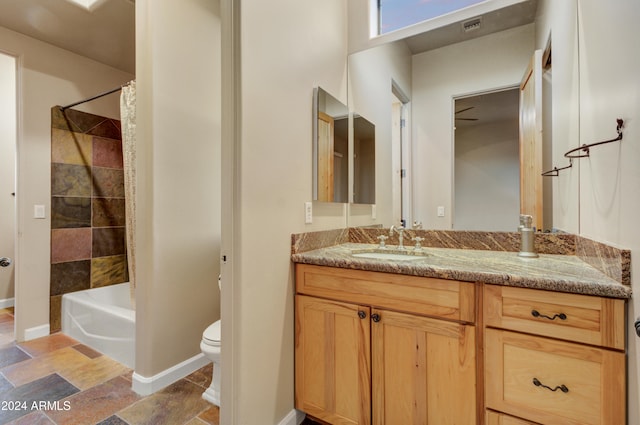 35824 N Tom Darlington Dr, Carefree, AZ 85377 - full bathroom with vanity, toilet, shower / bathtub combination with curtain, baseboards, and stone finish flooring