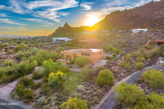 aerial view at dusk featuring a mountain view