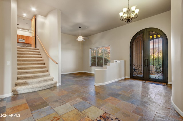 35824 N Tom Darlington Dr, Carefree, AZ 85377 - foyer with arched walkways, stone tile flooring, stairs, and a chandelier